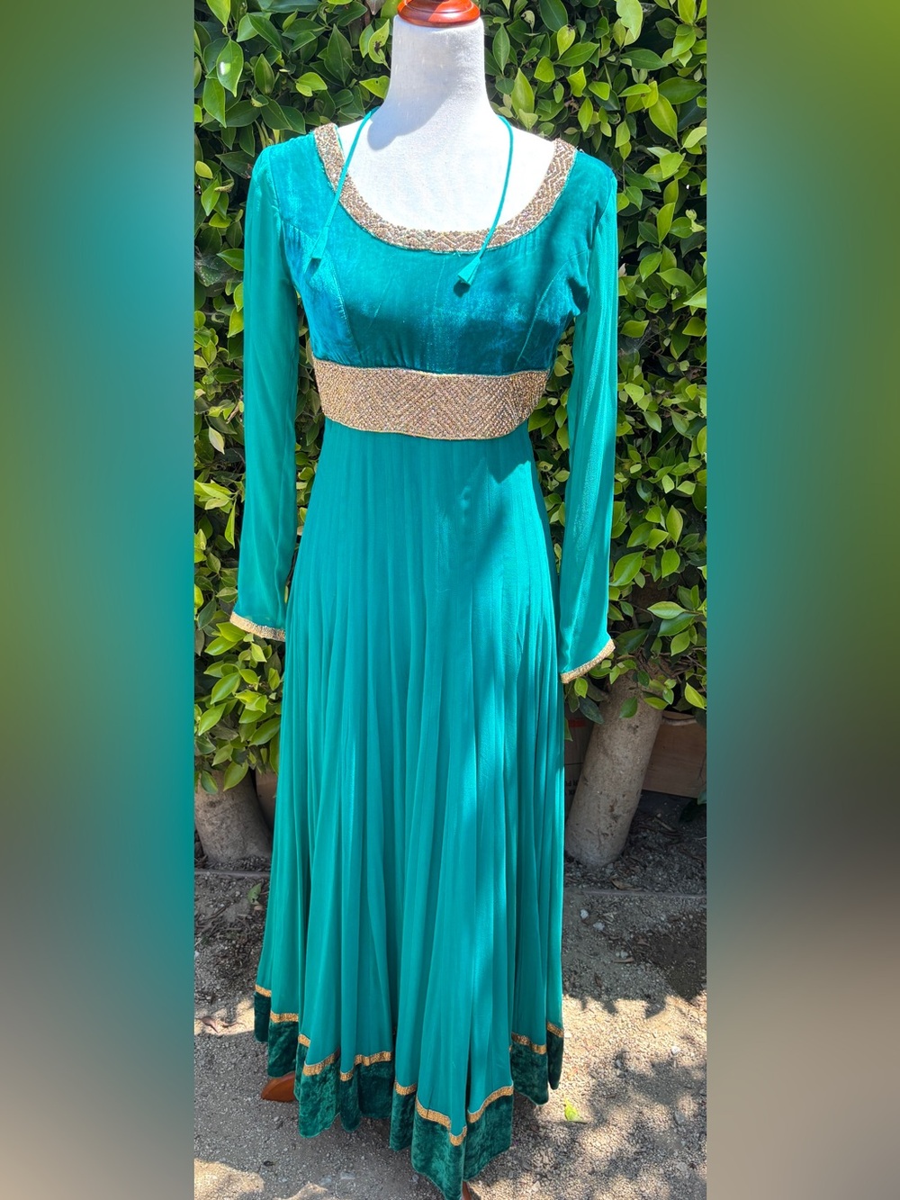 Teal Anarkali gown with intricate gold embroidery